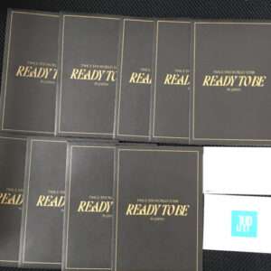Set of black tour booklets with gold 'READY TO BE' lettering, spread on a dark surface.