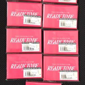 Several bright pink boxes labeled 'READY TO BE' arranged in a grid on a dark background, each with a barcode label.