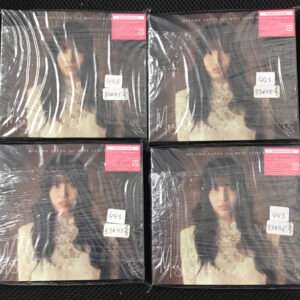 Four sealed copies of Misamo Japan 1st mini album, arranged in a 2x2 grid; cover features a woman with long dark hair in a light outfit, wrapped in plastic with pink stickers.