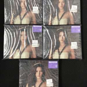 Six boxed copies of Misamo Japan mini album, each featuring a woman in a white strapless dress, sealed in plastic, arranged on a black surface.