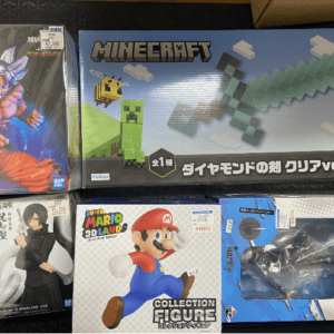 Collection of video game and figure boxes, including Minecraft set with a diamond sword and Mario figure box on top shelves.