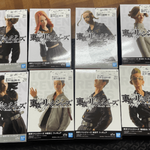 Eight Tokyo Revengers figure boxes laid out on a wooden surface, each showing a different character pose and outfit.
