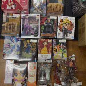 Top-down view of a large assortment of boxed anime figures on a wooden floor, features Naruto, Dragon Ball, One Piece, and Qposket lines still in packaging.