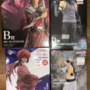 Four boxed anime action figures from Bandai Namco Masterlise displayed on a surface; two large boxes on top show male characters in dramatic poses, while two smaller boxes below feature other characters with swords and dynamic outfits.