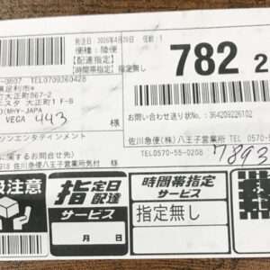 Japanese shipping label with multiple barcodes, sender/recipient info blocks, and service icons at the bottom (package tracking label).
