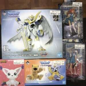 Large blue Bandai box featuring Imperialdramon with white wings and a gold sword; other boxed figures surround it on a shelf/lay flat surface.