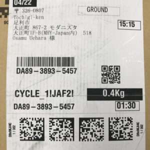 White shipping label with several barcodes and QR codes, showing date 04/22, time 15:15, weight 0.4 kg, and a Japan destination (Tochigi-ken).