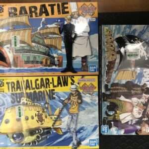 Three One Piece Grand Ship model kits from Bandai Namco: Baratie ship, Trafalgar Law’s submarine ship, and a third pirate ship set on colorful boxes.