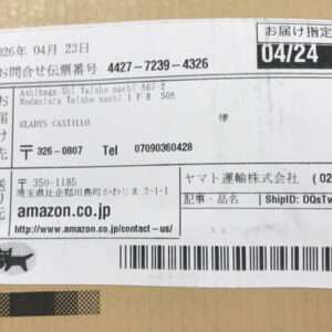 Shipping label on a brown box with Japanese text, dates, a barcode, and Amazon.co.jp as the sender.
