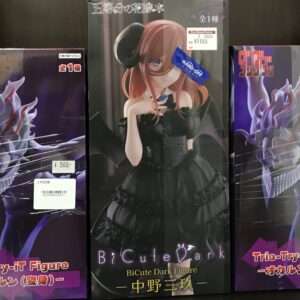 Center product box showing an anime girl with brown hair in a black gothic dress; price tag visible on top-right of the box.  Articulos Japan (Post Box Japan)
