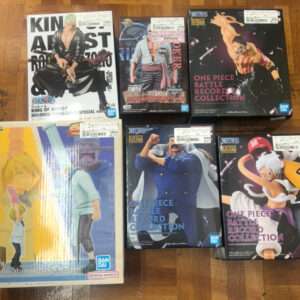 Six boxed One Piece figurines from Bandai arranged on a wooden floor, including Battle Record Collection and related lines.