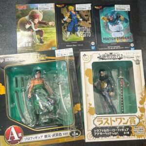 Boxed anime action figures laid on a dark surface: Naruto, Dragon Ball Z Vegito History Box, and Match Makers top row boxes, plus two larger boxed figures bottom row with swords.
