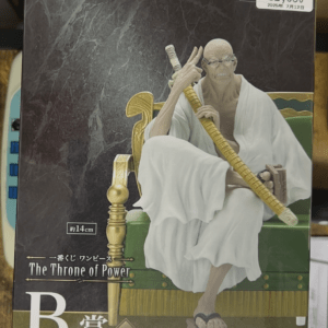 Boxed action figure of White-bearded monk sitting on a green throne, gripping a long yellow staff; packaging shows 'The Throne of Power' and Bandai Namco logos.