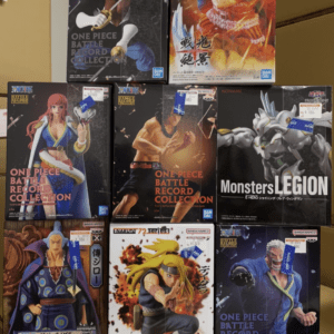 Boxes of One Piece Battle Record Collection figures on a shelf, featuring various characters in dynamic poses from Bandai Namco.