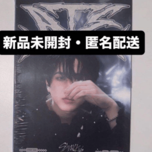 Sealed poster of a young man with dark hair, hand near his face, plastic-wrapped; black banner covers top with Chinese text.