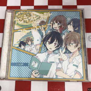 Anime-style CD cover with six students in white uniforms, one holding a teal book, bright striped background.