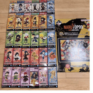 Grid of Naruto Top 99 collectible figurine boxes lined up on a wooden floor, with a large NarUTOP99 display box on the right.