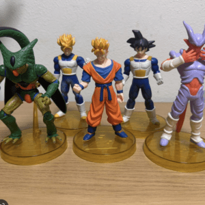 Dragon Ball Z action figures: Piccolo, two Saiyan-armored fighters, Goku in orange gi, and Frieza on yellow stands.