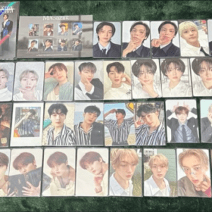 Grid of glossy photo cards featuring many young male idols arranged on a green surface.