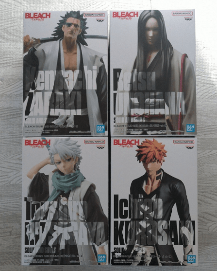スクリーンショット 2026-04-22 144928 - Articulos Japan (post Box Japan) Four Bleach character action figure boxes arranged in a 2x2 grid on a metallic surface, each box showing a different character portrait and bold title text. Articulos Japan (Post Box Japan)