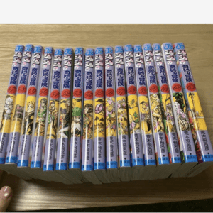 Row of colorful manga volumes stacked in a line on a wooden table, showing illustrated spines with Japanese text and numbered labels.