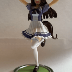 Figure of a female anime character with cat ears in a blue-and-white sailor uniform, arms raised, standing on a green circular display base with gray blocks.