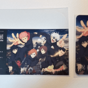 Framed poster and a matching card promoting a Jujutsu Kaisen exhibition, featuring several anime characters in dark outfits against a blue background.