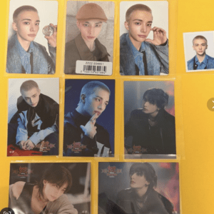 Collection of glossy photo cards showing a young man with short blond hair in various outfits on a yellow background.