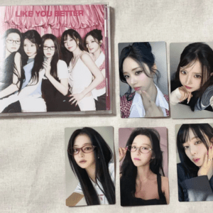 K-pop group album cover titled "Like You Better" showing six members posing together against a pink backdrop on a beige surface.