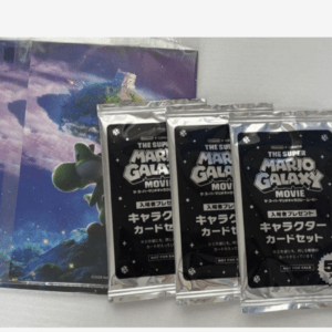 Three sealed 'The Super Mario Galaxy Movie' character card packs placed in front of a space-themed poster/artboard image.