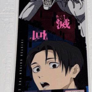 Vertical poster on a wall featuring a white masked figure looming above a surprised boy, with pink Japanese text and Bandai Namco branding (Jujutsu Kaisen poster).