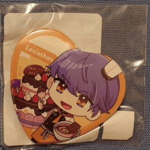 Round orange sticker with a chibi anime character having purple hair and a horn, eating cake joyfully.
