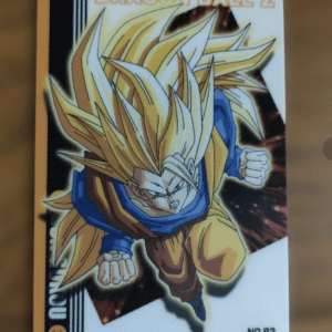 Dragon Ball Z trading card showing a Super Saiyan character in orange gi and blue undershirt, hair spiked yellow, charging forward (No.83).
