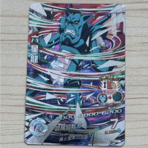 Colorful trading card showing a blue muscular monster breaking through energy swirls, with Japanese text and RPG-style stats on the card.