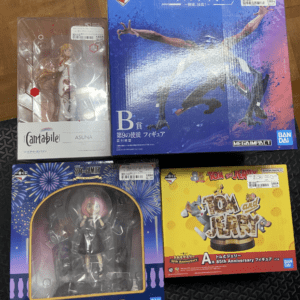 Cantabile Asuna figure in a clear display box on a wooden floor with price sticker visible on the packaging.