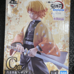 Boxed C-prize figure of Zenitsu Agatsuma from Demon Slayer, in orange haori with white triangles, gripping a sword against a floral background.