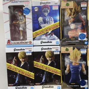 A display of six Grandista action figure boxes on a shelf, featuring anime characters in colorful outfits.
