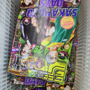 Colorful Japanese manga magazines stacked in a white basket.  Articulos Japan (Post Box Japan)