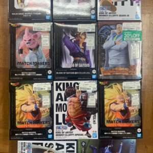 Grid of boxed Dragon Ball Z and One Piece figurines on a wooden floor, showing various character figures and price stickers sold by Bandai Japan.