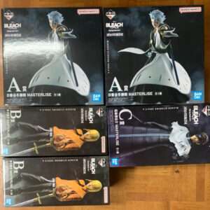 Box set featuring Bleach Masterlise figures; two white-cloaked character boxes and four others laid out on a wooden floor, with Bandai Namco branding visible.