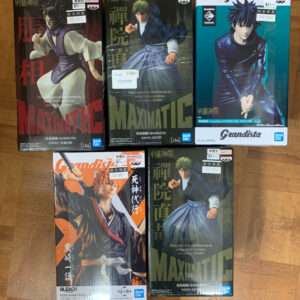 Six Bandai Namco figure boxes (Grandista/Maximatic) laid on a wooden floor, showing anime characters in action poses.