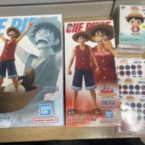 Two large One Piece figure boxes featuring Monkey D. Luffy; left box shows Luffy with arms raised on a wooden ship, right box shows Luffy standing with a red background and a stern expression.