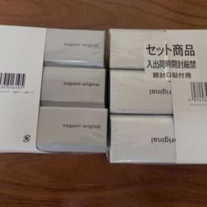 White boxes arranged in two columns on a wooden surface, labeled “sagami original” with a Japanese sticker on the right box and barcodes visible.