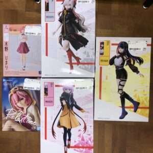 Boxed anime figure set arranged on a wooden floor, featuring five different character statues with colorful packaging on display.