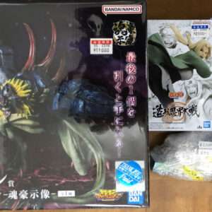 Large Bandai 'Last One' boxed figure of a dark dragon/demon creature on a wooden floor. Japanese text visible on box.