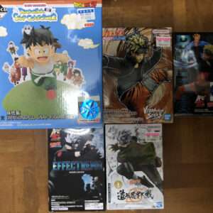 Blue Dragon Ball Snap Collection 2 box featuring Goku on a green orb, on a wooden floor with other character stickers nearby.