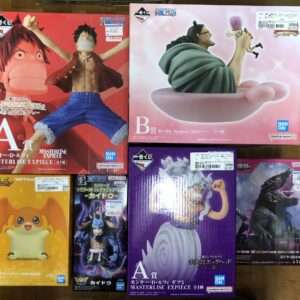 Boxed anime figures from Bandai Namco, including Luffy and other One Piece characters, arranged on a table with colorful packaging.  Articulos Japan (Post Box Japan)