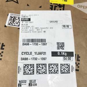 Shipping label on a cardboard box with destination address, weight 0.1 kg, and barcodes/QR codes.