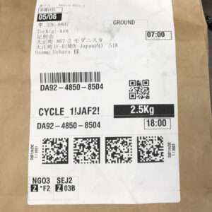 Shipping label on a brown cardboard box showing destination and tracking details, barcodes, a QR code, and a weight of 2.5 kg (Ground service).