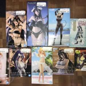 Row of boxed anime figurines featuring women in fantasy swimsuits and outfits on a wooden floor store display (price tags visible).